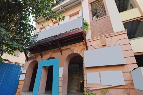 a building with a blue sign on the side of it at Hotel Amber Sun City in Mumbai