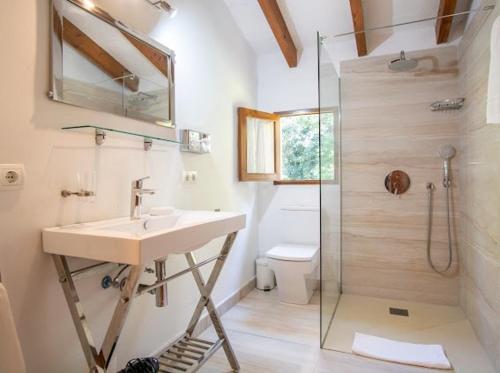 a bathroom with a sink and a shower at Can Gat in Pollença