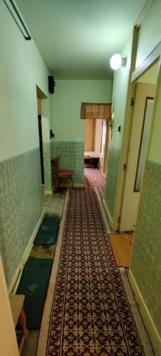 an empty room with a hallway with a rug on the floor at Apartament Bozias Muncitori in Tîrnăveni