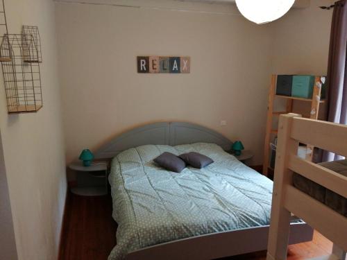 a bedroom with a bed with two pillows on it at Gîte La Rocardière XL 10 personnes in Mouchamps