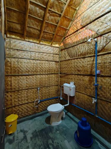 a bathroom with a toilet in a brick wall at The Sundown Hampi in New Hampi