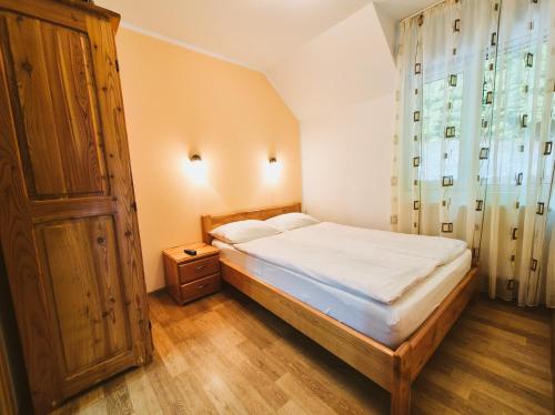 a bedroom with a bed and a large window at Casa Sonne Bușteni in Buşteni