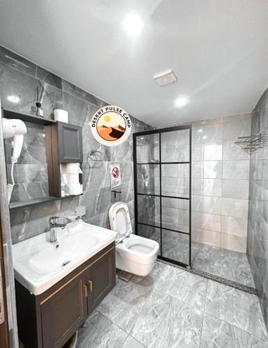 a bathroom with a toilet and a sink and a shower at RUM BULSE BUBBLE lUXURY CAMP in Wadi Rum