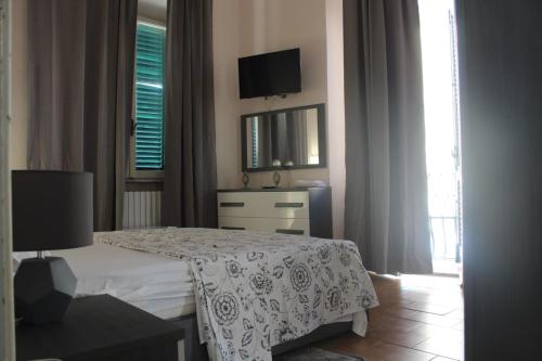 a bedroom with a bed and a tv on the wall at La Stazione #1 in Pontedera