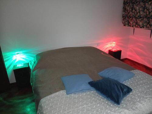 a bedroom with a bed with lights on it at Flat all for you in Treviso