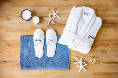 a pair of flip flops and a towel next to a pair of towelsurrection at Fairmont The Palm Residences I Access to Hotel Facilities in Dubai