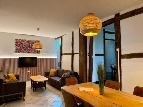 a living room with a couch and a table at Au petit Clocher - vakantiehuis Ardennen in Ferrières