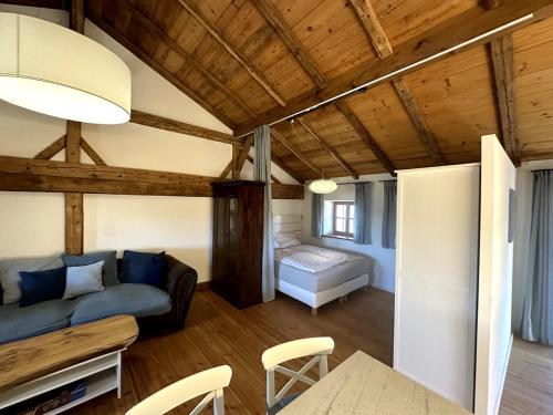 a living room with a couch and a bed at Moderne Landhaus Loft Nähe Mühldorf am Inn 