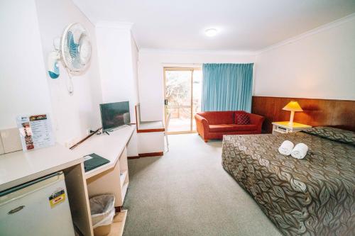 a hotel room with a bed and a desk at Augusta's Georgiana Molloy Motel in Augusta