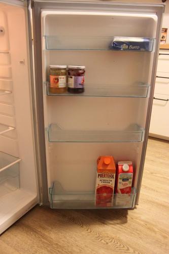 an open refrigerator with some food inside of it at B&B Color Rovereto in Rovereto