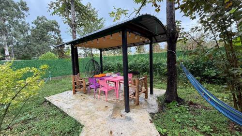 a picnic table in a gazebo in a garden at Romantic Villa 2BR by the Sea in Tsikhisdziri