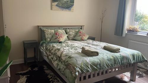 a bedroom with a bed with pillows on it at The Rookery Sandside - Stylish luxury Home 