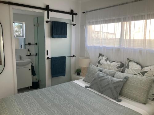 a bedroom with a bed and a window and a sink at Quiet,1 x Queen, Farm Stay Self-Contained unit in Empire Vale