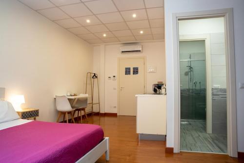 a bedroom with a bed and a bathroom with a shower at LHE Les Trois Merveilles Rosé Charles in Cesena