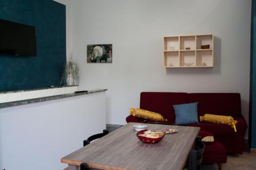 a living room with a table and a couch at The Liberty Palace in Campobello di Licata