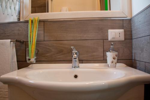 a white sink in a bathroom with a mirror at The Liberty Palace in Campobello di Licata