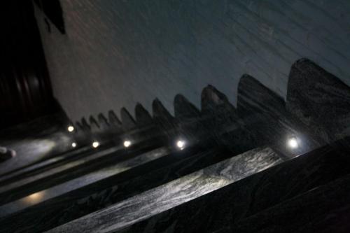 a row of benches in the snow at night at The Liberty Palace in Campobello di Licata