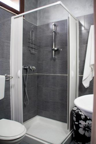 a bathroom with a shower and a toilet and a sink at The Liberty Palace in Campobello di Licata