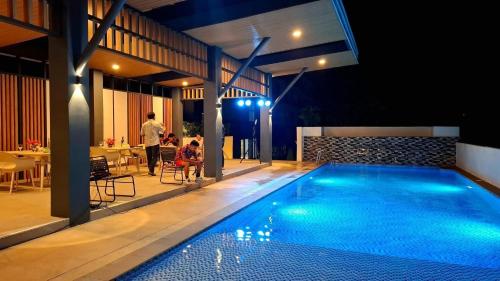 a swimming pool in the middle of a house at night at Awe-some Homestay in Mandaue City