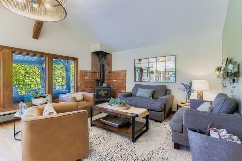 a living room with two couches and a table at RollinsVilla home in Rollinsville