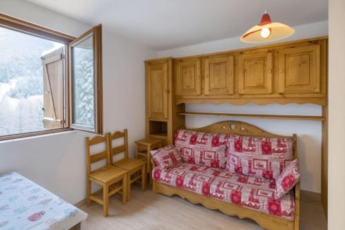 a bedroom with a bed and a chair and a window at Vue Des "Chavants" Studio 20 M With Balcony in Les Houches