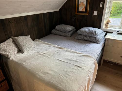 a small bedroom with a bed and pillows on it at Villa Margit ground floor apartment in Tvååker