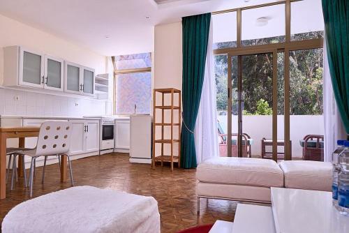 a kitchen and living room with a table and chairs at Garden Hills Hotel in Addis Ababa