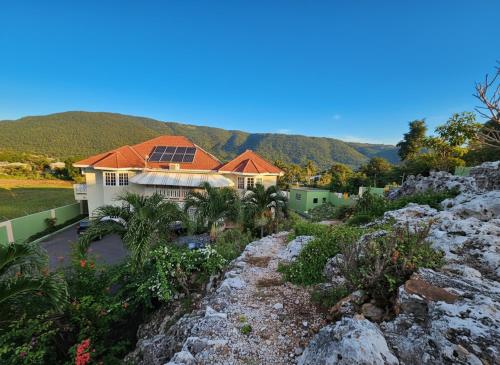 a house on a hill with mountains in the background at Private Villa Paradise - Pool & Mountain Views in Top Hill