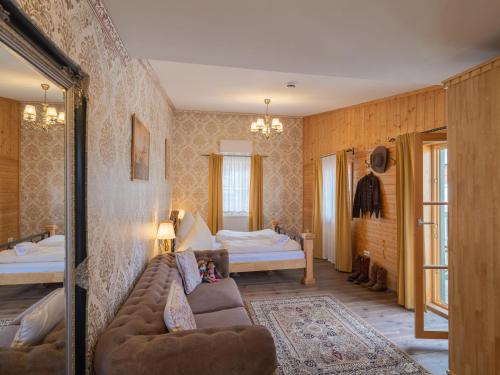 a living room with a couch and a bed at Pullman City Westernstadt in Eging am See