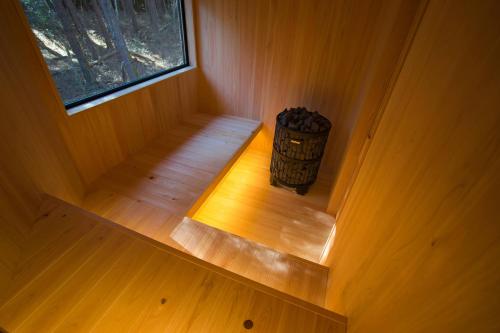 an inside view of a wooden room with a window at FujiSaunaVillage グランピングテント in Fujikawaguchiko