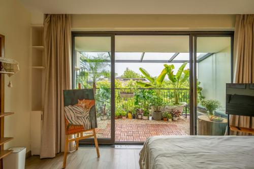 a bedroom with a view of a patio at Leng Ecopark Vangogh Hideaway in Kim Quan