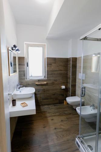 a bathroom with two sinks and two toilets at Luna di Sale - Romantic Sea Rooms & Apartments in Reggio di Calabria