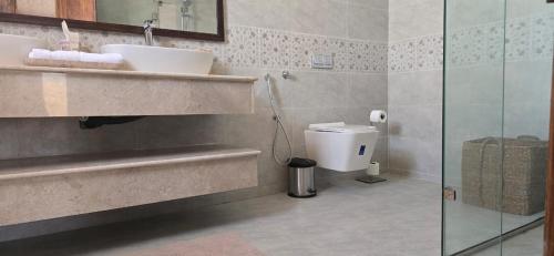 a bathroom with a sink and a toilet at Desert Escape Camp Wahiba in Ibrā