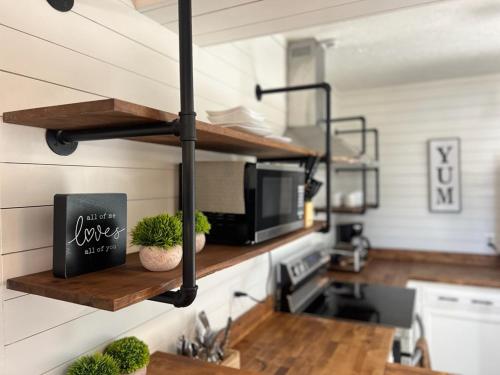 a kitchen with a microwave and a counter with plants at Turkey Nest By Beyond Expectations Renovated 2br in Gatlinburg