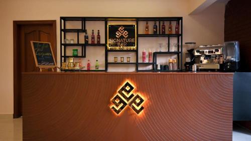 a bar with an exit sign in a restaurant at Clifton Business Hotel in Karachi