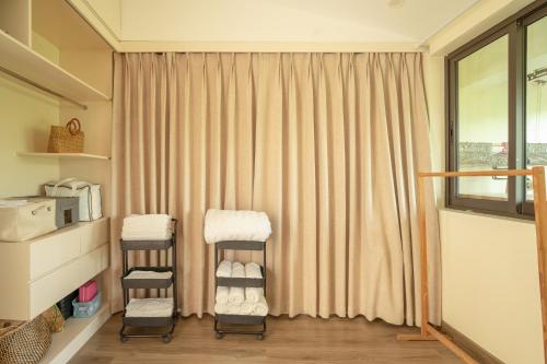 Kim QuanにあるLeng Ecopark Vangogh Hideawayの窓の前に2脚のスツールが備わる部屋