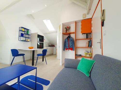 a living room with a couch and a table at Du Peps au coeur d'Angers ! in Angers