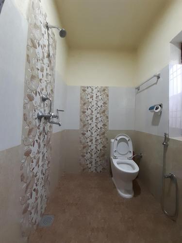 a bathroom with a toilet and a shower at Hotel Eco Friendly Pvt in Thāre Pāti