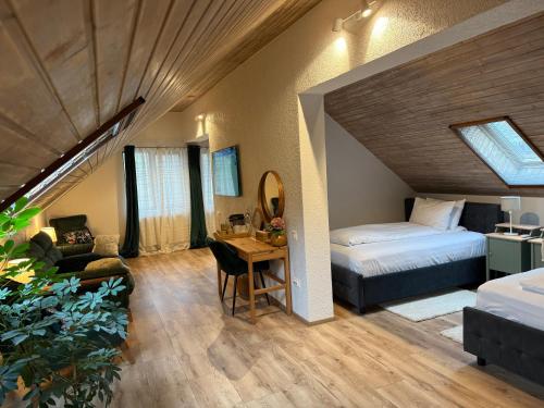 a bedroom with a bed and a desk in a room at Silvan Villa - Apart in Sighişoara