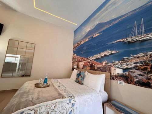 a bedroom with a large painting on the wall at Arenaccia House Naples Center Welcome Wine in Naples