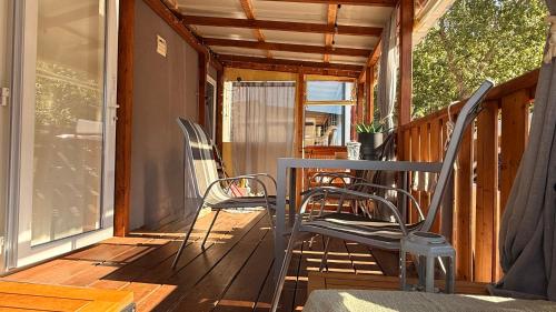 two chairs sitting on the porch of a house at Mobile home MARIS in Sveti Juraj
