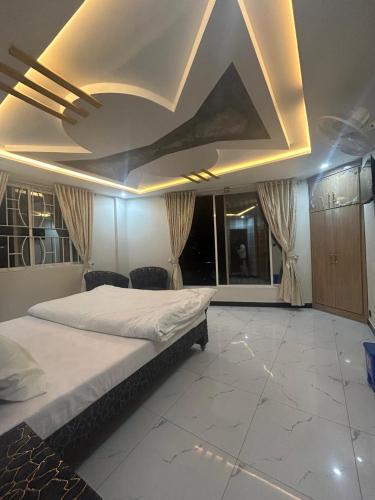 a bedroom with a large bed with a coffered ceiling at askari lodges in Murree