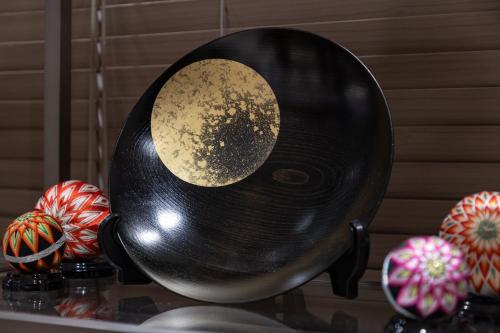a black vinyl disk with a moon on it at HOTEL MYSTAYS Kanazawa Katamachi in Kanazawa