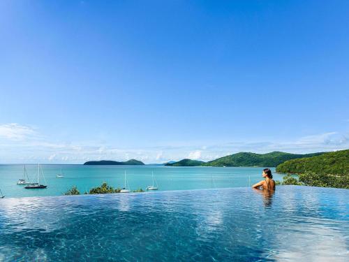 a person in a infinity pool in a body of water at V Villas Phuket - MGallery Collection in Panwa Beach