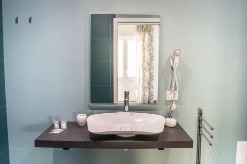 a bathroom with a sink and a mirror at hiPaestum in Paestum