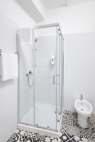 a shower stall in a bathroom with a toilet at Hotel Aurelia Milano Centrale in Milan