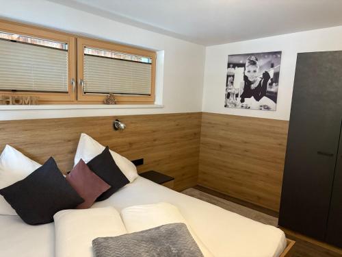 a bedroom with a bed and a window at APART six-o-nine in Schwendau