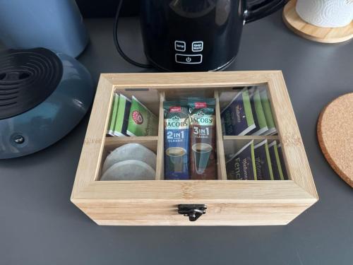 a wooden box filled with books on a table at Ferienwohnung mit vollausgestatteter Küche - SmartTV I Free Netflix I 24h Check in in Bielefeld