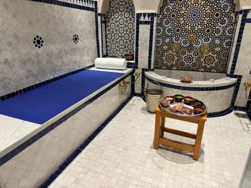 a bathroom with a tub and a table with food on it at Riad Dar Laura in Fès