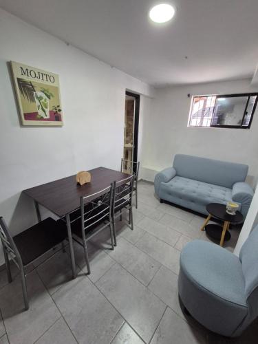 a living room with a table and a couch at Apartamento centro de pereira a 2 cuadras del hospital san jorge in Pereira